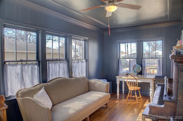 living room with crown molding, ceiling fan, and hardwood / wood-style flooring