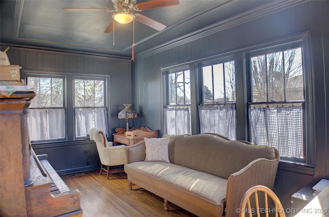 living room featuring hardwood / wood-style flooring, ornamental molding, a healthy amount of sunlight, and ceiling fan