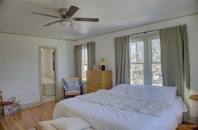 bedroom with ceiling fan, ensuite bath, and light hardwood / wood-style flooring