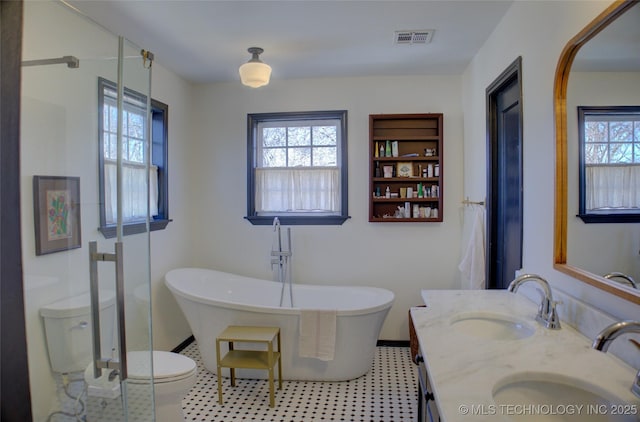 bathroom featuring vanity, a tub, and toilet