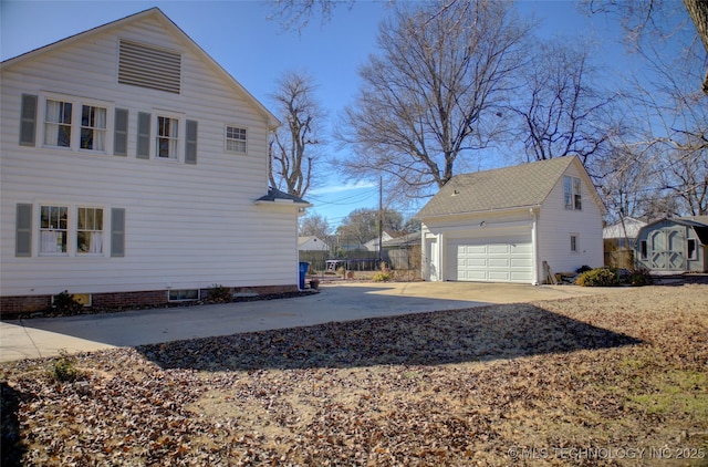 view of property exterior featuring an outbuilding and a garage