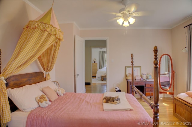 bedroom with crown molding, ceiling fan, and light wood-type flooring