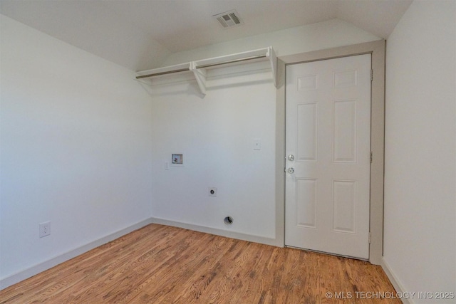 clothes washing area with washer hookup, hookup for an electric dryer, and wood-type flooring