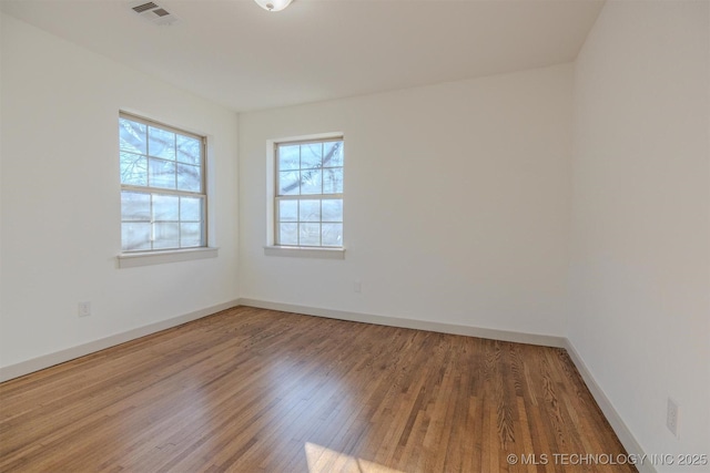 spare room featuring hardwood / wood-style flooring