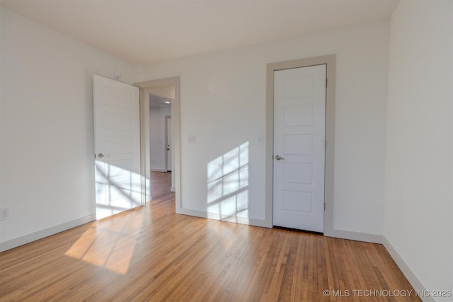 spare room with light hardwood / wood-style flooring