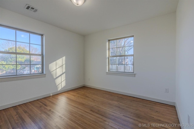 empty room with dark wood-type flooring