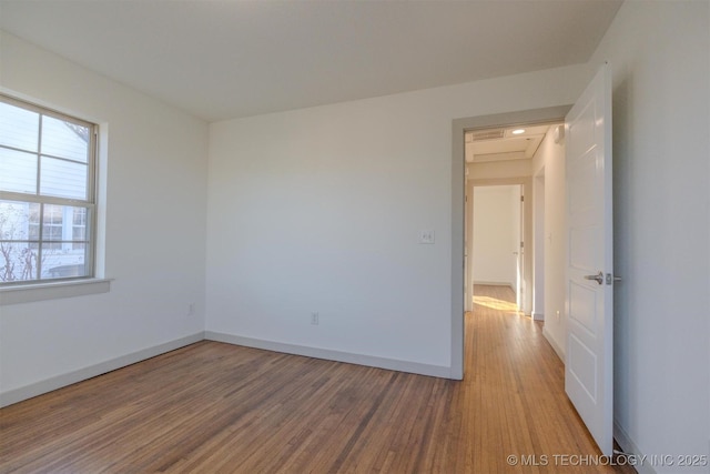 empty room with hardwood / wood-style flooring