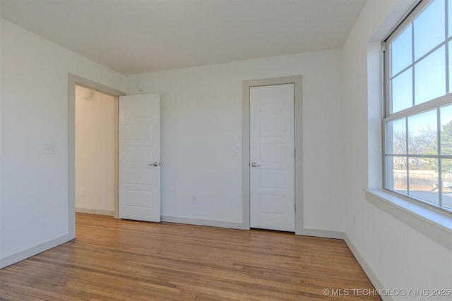 unfurnished bedroom featuring light wood-type flooring