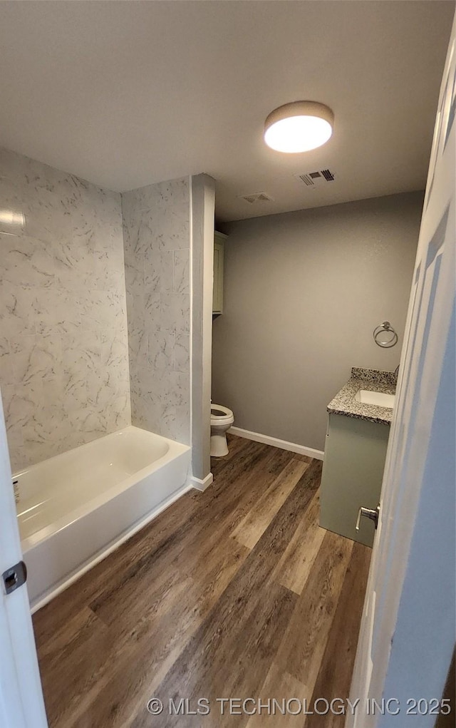 bathroom with vanity, hardwood / wood-style floors, and toilet