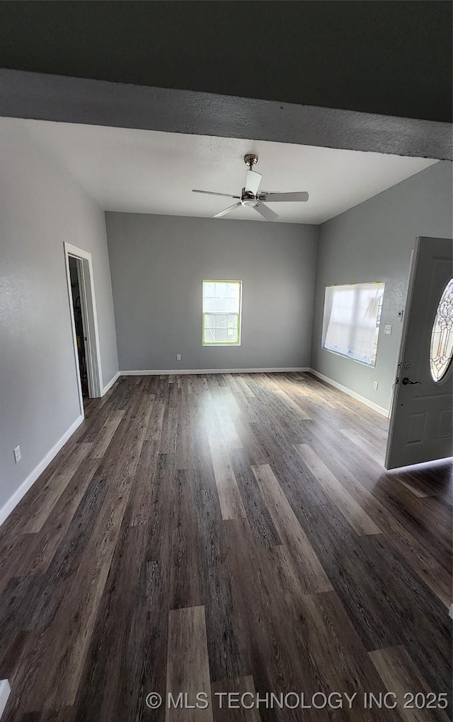 unfurnished room with dark wood-type flooring and ceiling fan