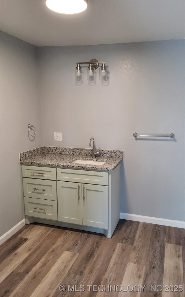 bathroom with vanity and hardwood / wood-style floors