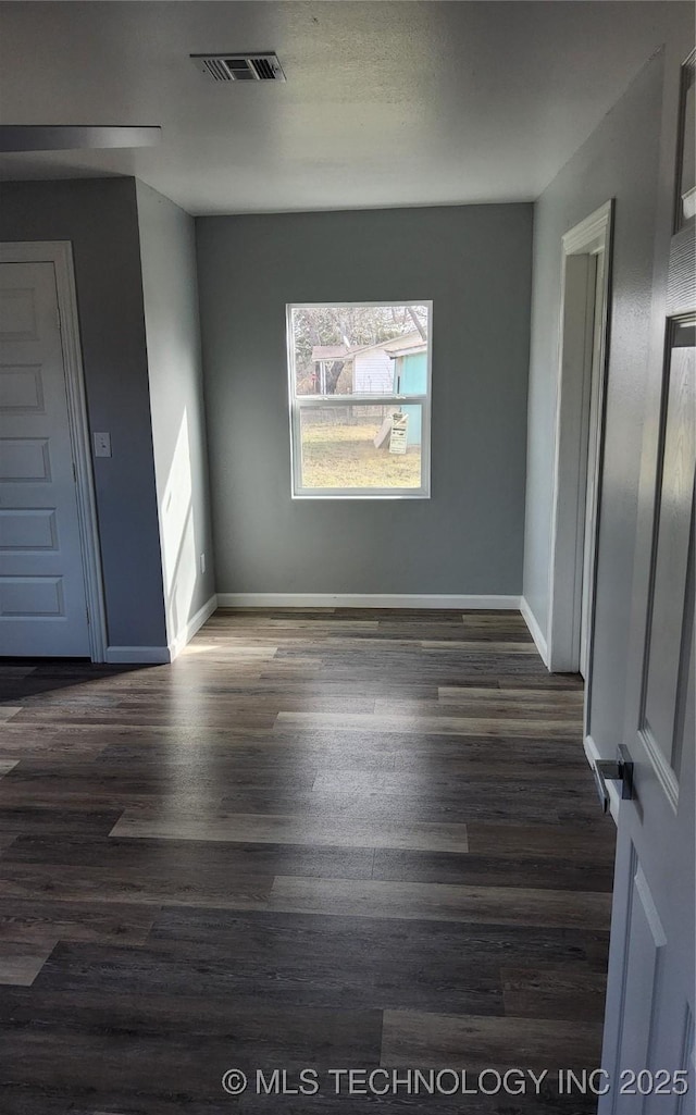 unfurnished room featuring dark hardwood / wood-style flooring