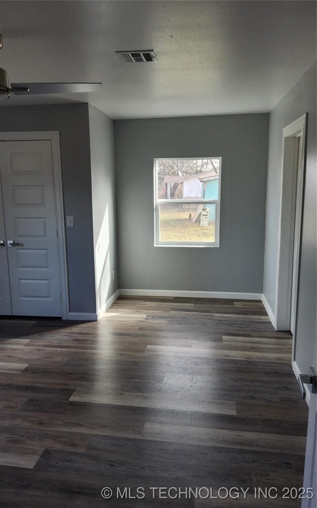 unfurnished room featuring dark hardwood / wood-style flooring