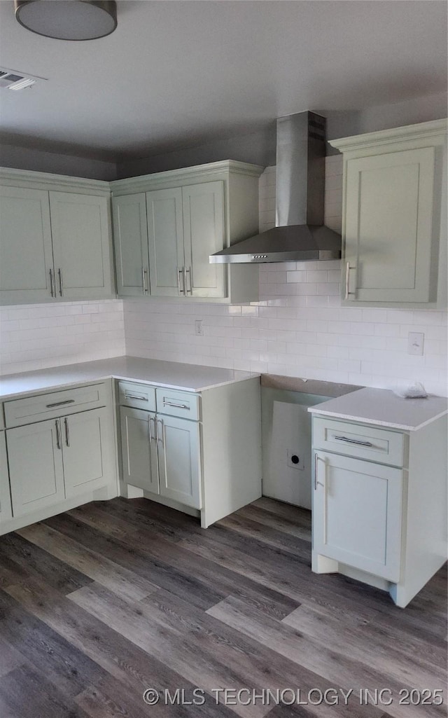 kitchen with white cabinets, decorative backsplash, dark hardwood / wood-style floors, and wall chimney exhaust hood