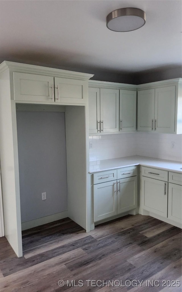 kitchen featuring white cabinetry, dark hardwood / wood-style floors, and decorative backsplash