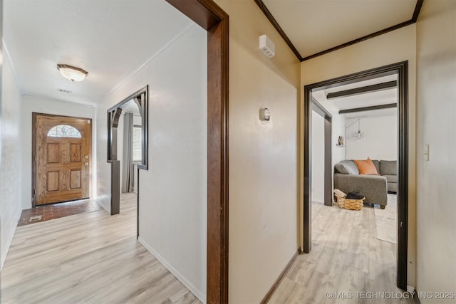 hall featuring ornamental molding and light hardwood / wood-style floors