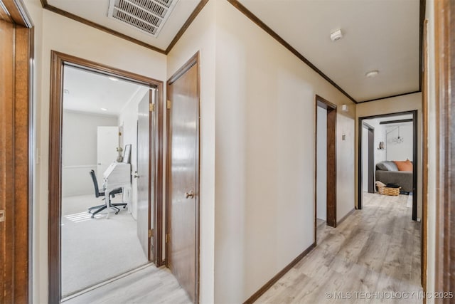 corridor featuring ornamental molding and light hardwood / wood-style floors