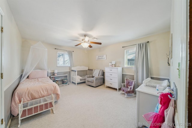 bedroom featuring light carpet and ceiling fan