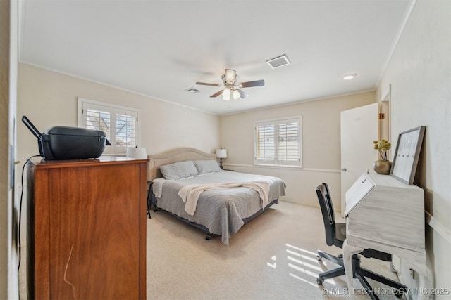 bedroom with crown molding, light colored carpet, and ceiling fan