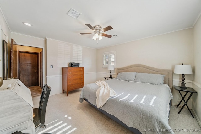 carpeted bedroom with crown molding and ceiling fan