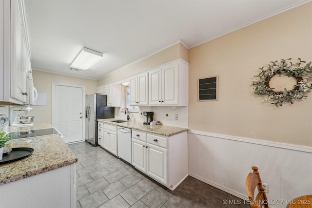 kitchen featuring white cabinetry, stainless steel fridge, white dishwasher, and light stone counters