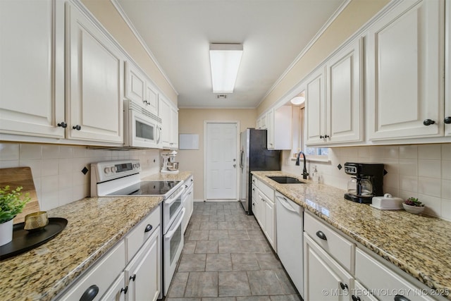 kitchen with white cabinetry, sink, and white appliances