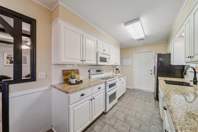 kitchen featuring white cabinetry, white appliances, sink, and light stone counters