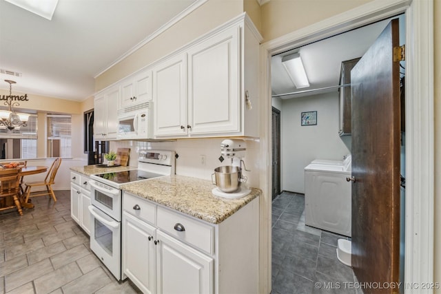 kitchen with separate washer and dryer, white cabinets, decorative backsplash, white appliances, and an inviting chandelier