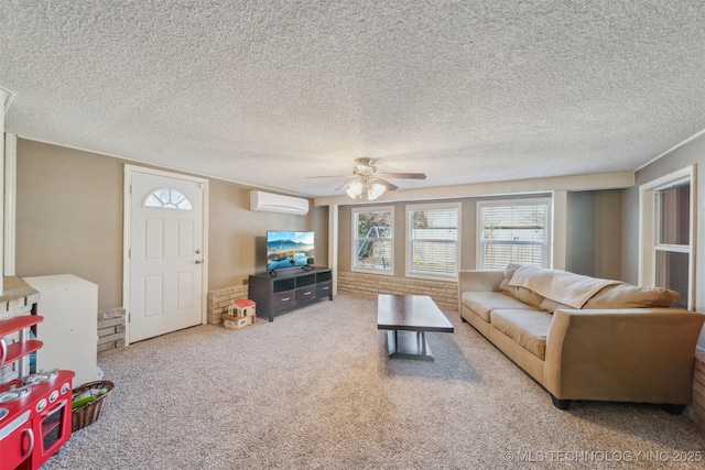 living room with a wall mounted air conditioner, a textured ceiling, ceiling fan, and carpet