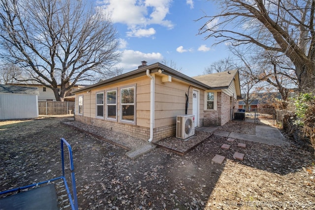 view of side of home with ac unit and central AC unit