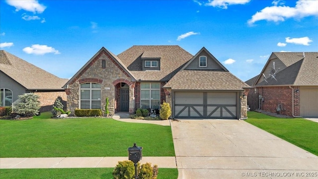 view of front of home featuring a garage and a front yard