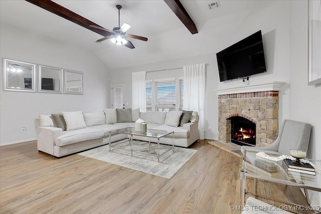 living room featuring vaulted ceiling with beams, a fireplace, ceiling fan, and light wood-type flooring