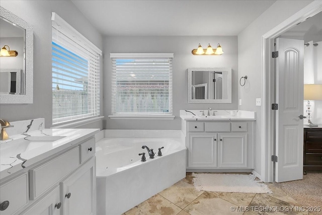 bathroom with vanity, tile patterned flooring, and a washtub