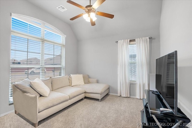 living room with ceiling fan, lofted ceiling, and carpet