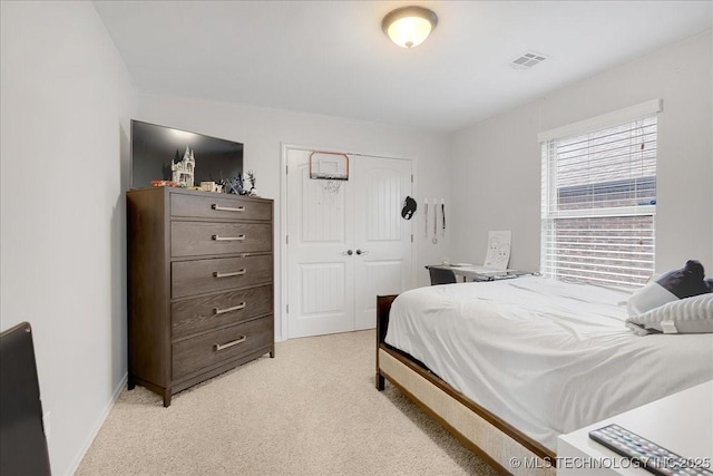 carpeted bedroom with a closet