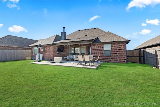 back of house with a yard and a patio area