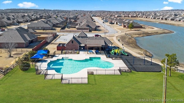 view of pool featuring a patio and a yard