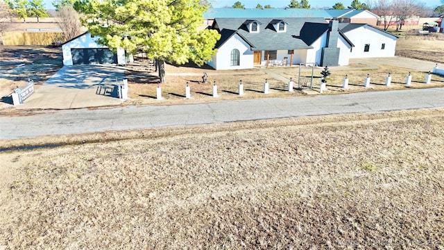 view of front facade with a garage and an outbuilding