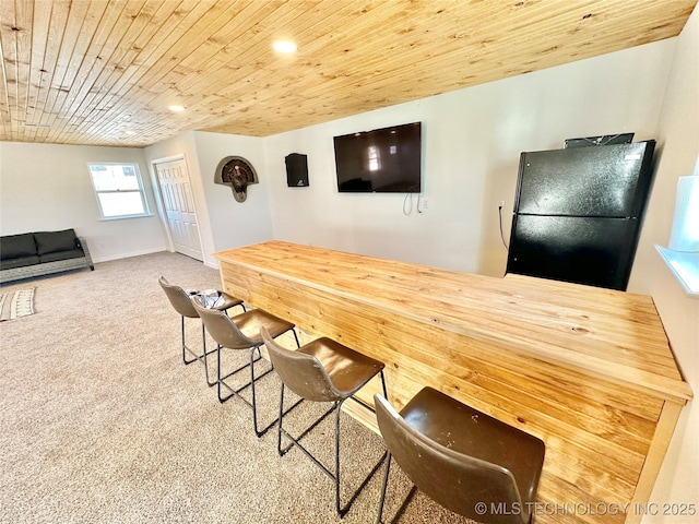 dining room with carpet and wooden ceiling