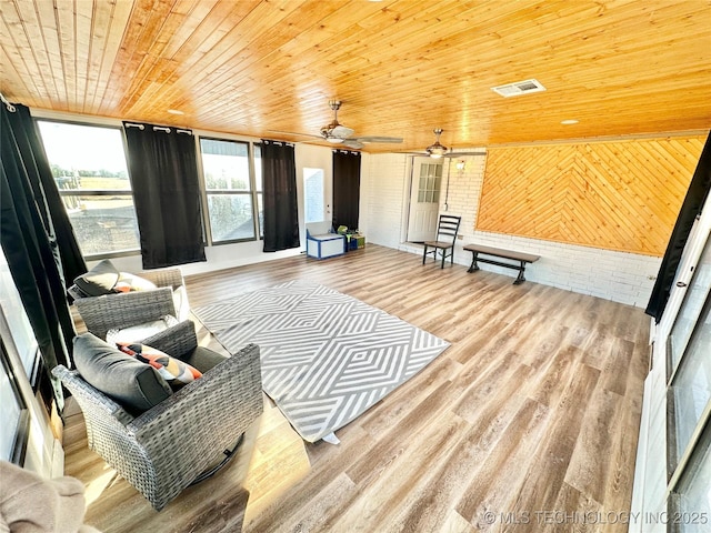 living room with wood-type flooring, wooden walls, and wooden ceiling