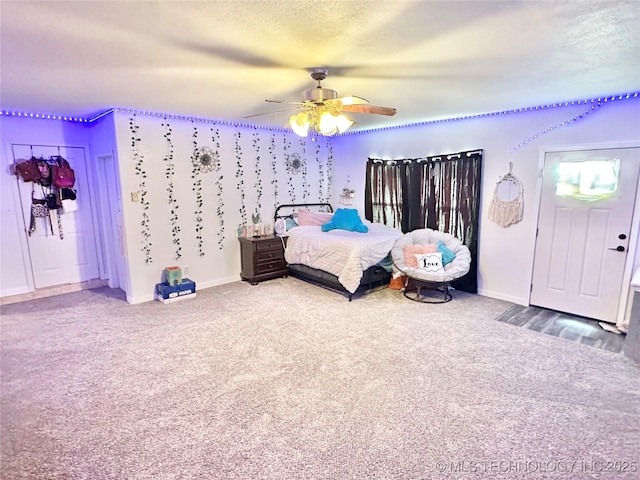 bedroom featuring ceiling fan, carpet flooring, and a textured ceiling