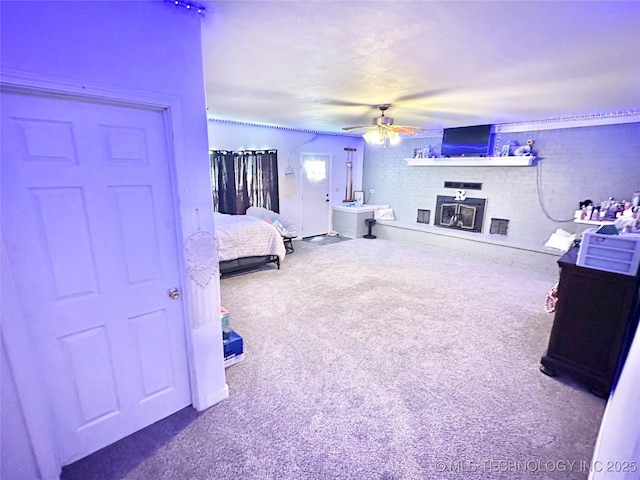 carpeted bedroom featuring ceiling fan and a brick fireplace