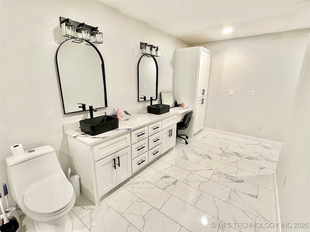 bathroom featuring vanity and toilet