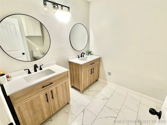 bathroom with vanity and toilet