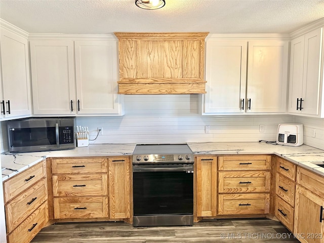 kitchen with white cabinetry, appliances with stainless steel finishes, dark hardwood / wood-style floors, and a textured ceiling