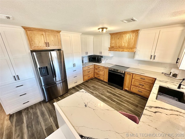 kitchen featuring appliances with stainless steel finishes, dark hardwood / wood-style floors, sink, white cabinets, and custom exhaust hood