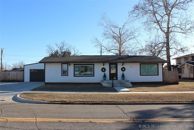 single story home featuring an outbuilding and a garage