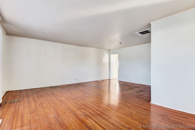 spare room with wood-type flooring