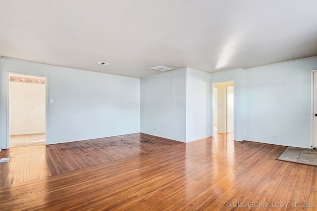 unfurnished room with wood-type flooring