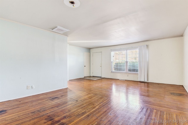 spare room featuring hardwood / wood-style floors and ornamental molding